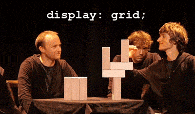 caption says `display: grid;`, man grabs a block from a tower of horizontally and vertically balanced wood blocks and they all fall nicely into a single row, the caption updates to `display: flex;`
